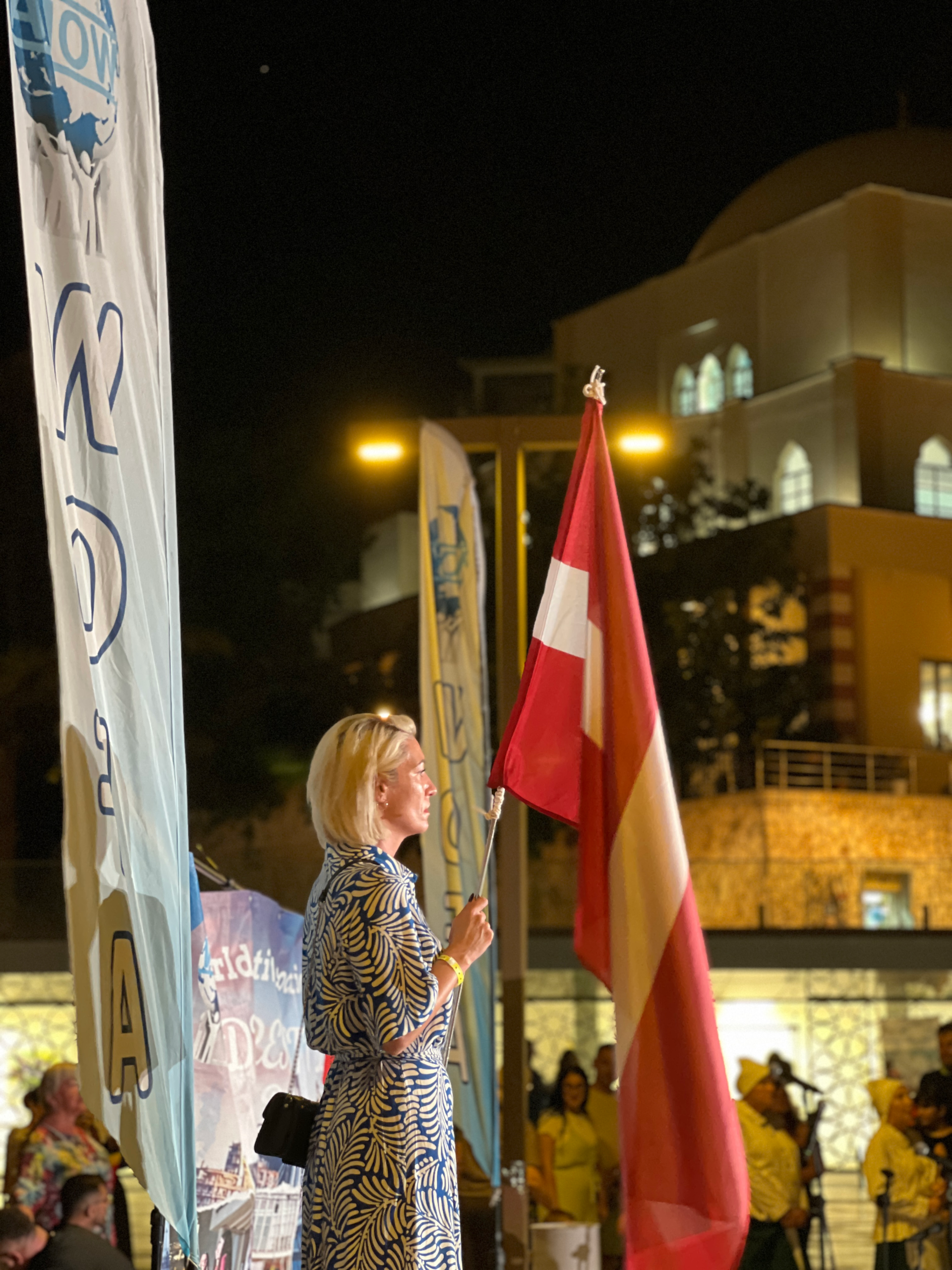 Female holding the flag of Latvia at the WOFA Festival in Durres
